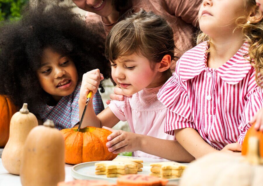 young-kids-carving-halloween-jack-o-lanterns_53876-41199 (1)