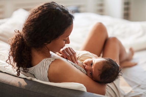 young-mother-breastfeeding-baby-baby-home