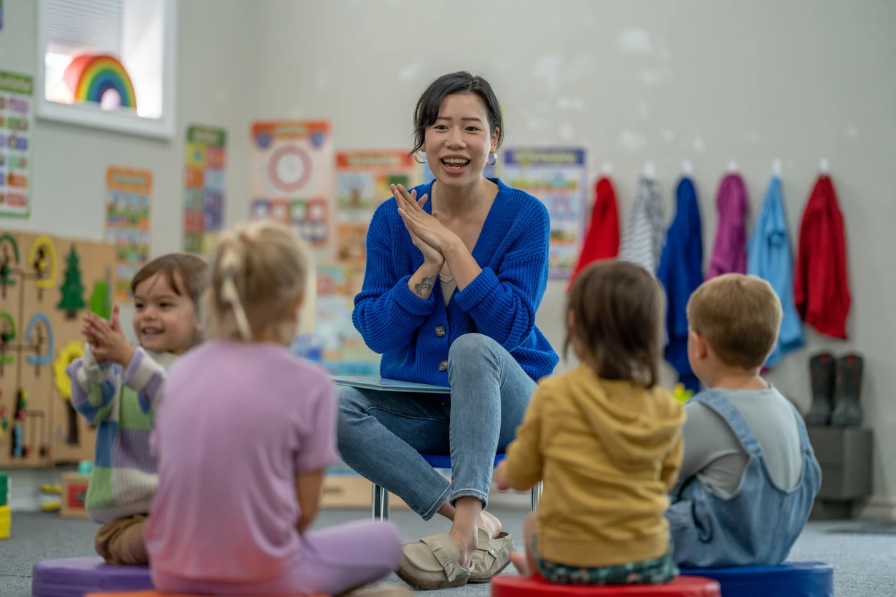 Story Time with preschoolers and young Asian Teacher